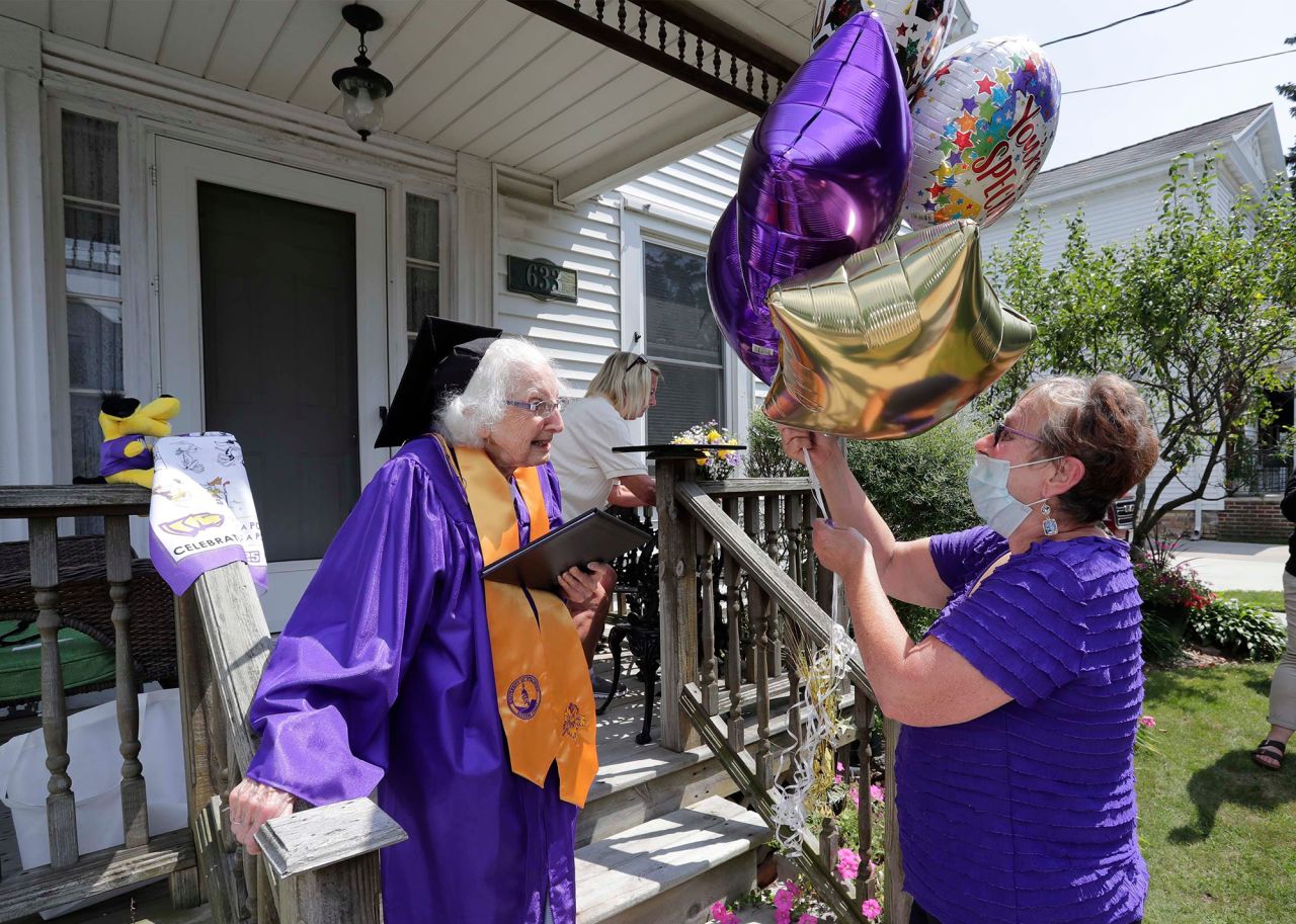 Virginia Posny, 99, receives balloons as she gets her associate's degree from the University of Wisconsin-Stevens Point on Monday, August 10. It was discovered that Posny earned enough credits in 1939-40 to earn the degree.