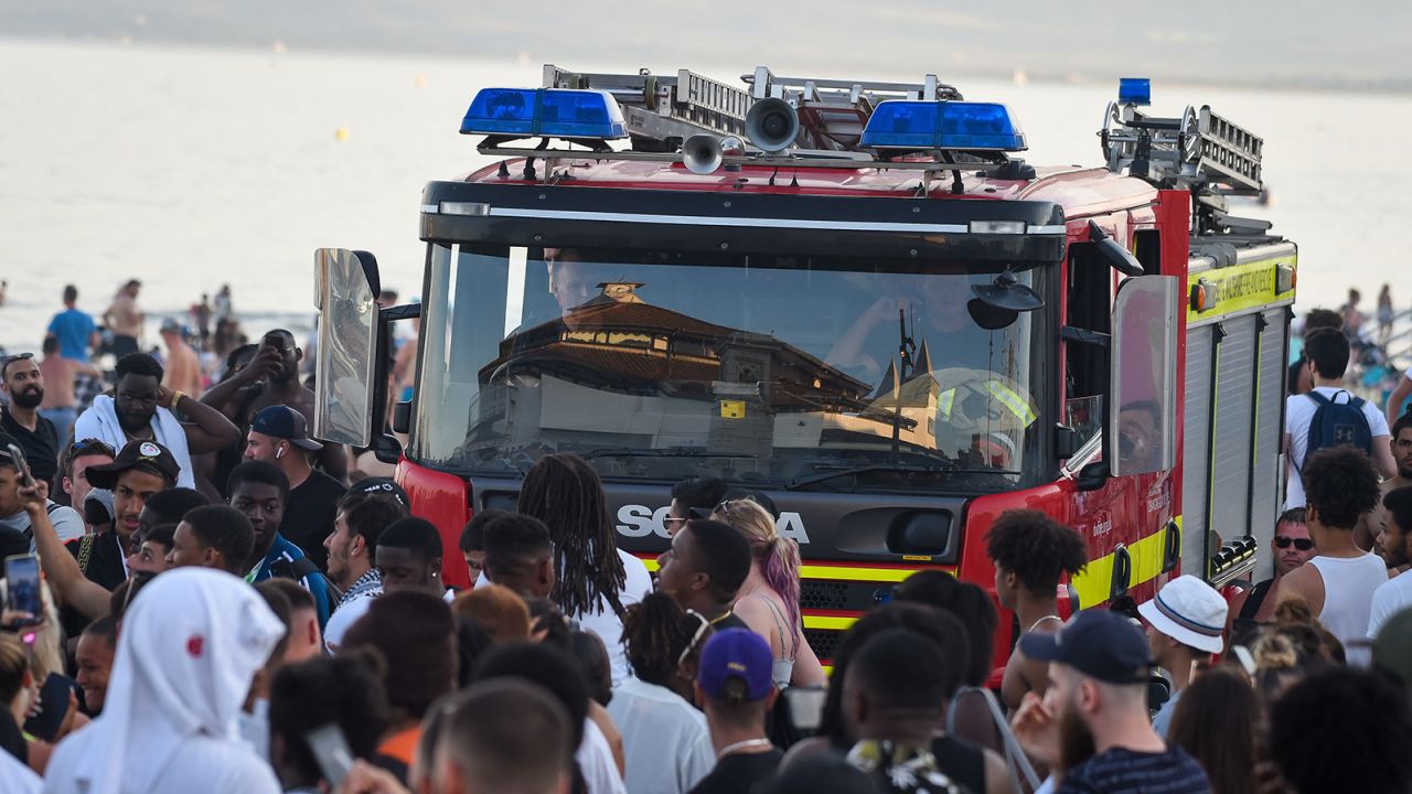 A fire engine struggles through the crowds on the promenade at Bournemouth in June.