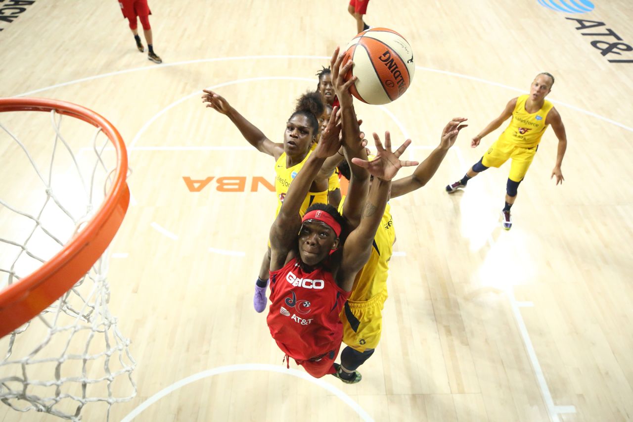 Washington's Myisha Hines-Allen, bottom, reaches for a rebound during a WNBA game against the Indiana Fever on Sunday, August 9. 