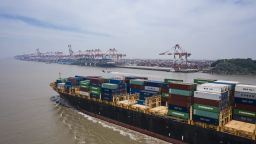 The Kota Cepat vessel loaded with shipping containers approaches the Yangshan Deepwater Port in this aerial photograph taken in Shanghai, China, on Sunday, July 12, 2020.
