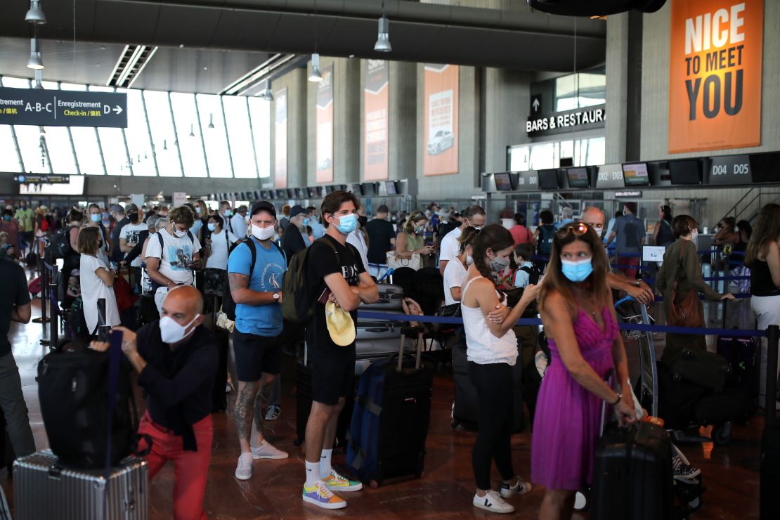 People hoping to beat the new quarantine rules check in at Nice airport in the south of France for a flight to London on Friday.