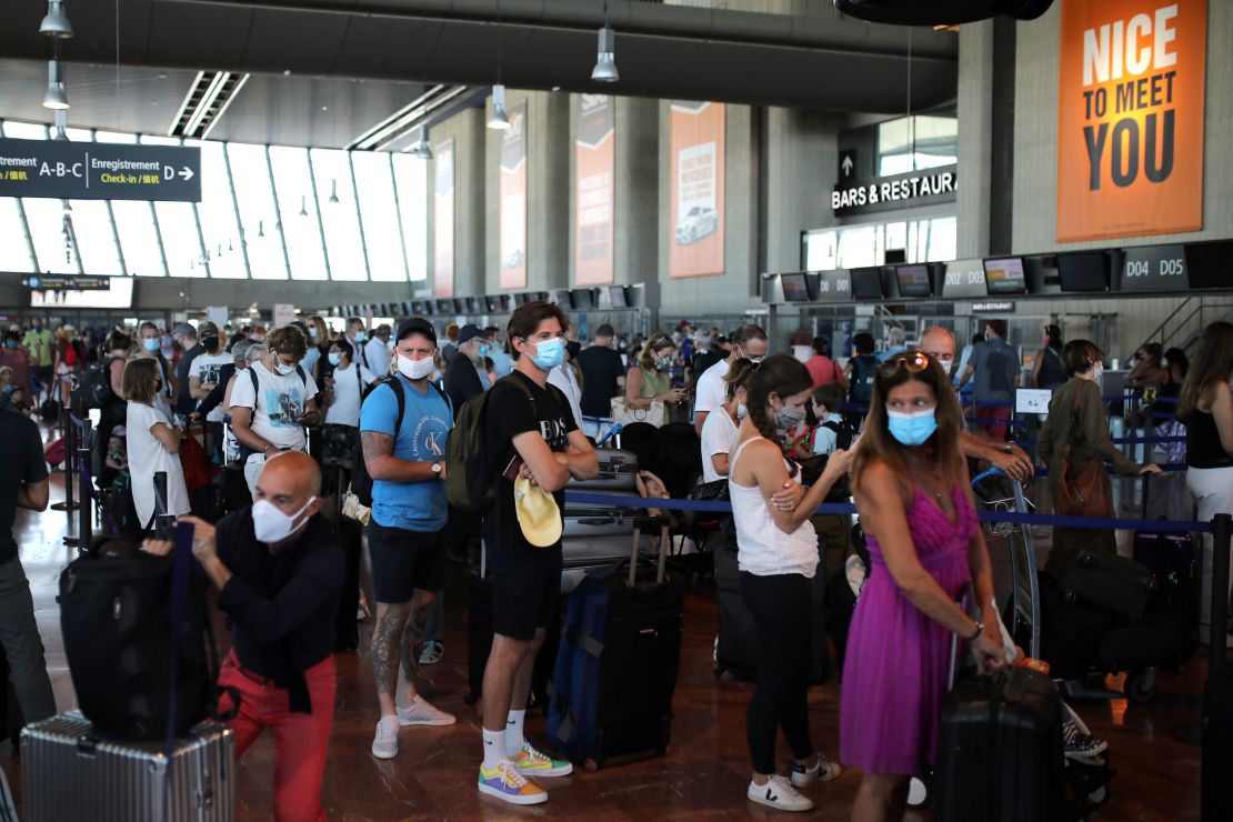 People hoping to beat the new quarantine rules check in at Nice airport in the south of France for a flight to London on Friday.