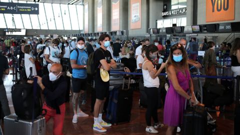 People hoping to beat the new quarantine rules check in at Nice airport in the south of France for a flight to London on Friday.