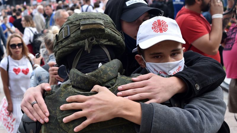 At least 50 Belarus riot police drop shields and are embraced by anti-government protesters - CNN team in Minsk