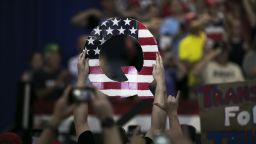 An attendee holds signs a sign of the letter "Q" before the start of a rally with U.S. President Donald Trump in Lewis Center, Ohio, U.S., on Saturday, Aug. 4, 2018. Trump defended his use of tariffs that have inflamed tensions with China and Europe, telling an audience of diehard supporters on Saturday that playing hardball on trade is "my thing." Photographer: Maddie McGarvey/Bloomberg via Getty Images