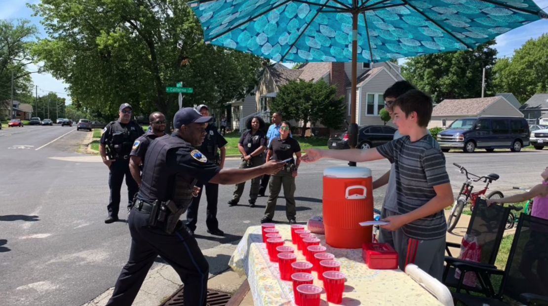 Peoria police officers lined up to purchase lemonade from the stand.