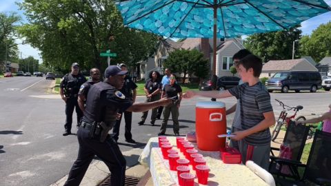 Peoria police officers lined up to purchase lemonade from the stand.