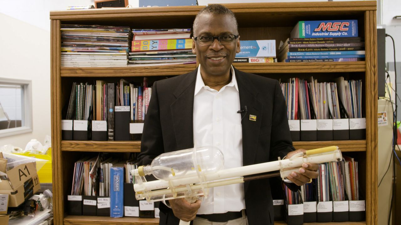 Dr. Johnson holds a prototype for the Super Soaker.