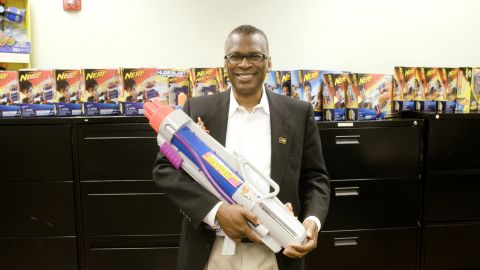Dr. Lonnie Johnson holding one of his most famous inventions, the Super Soaker.