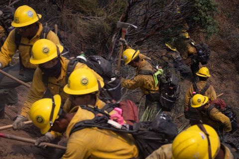 A firefighter crew works in Lake Hughes on August 13.