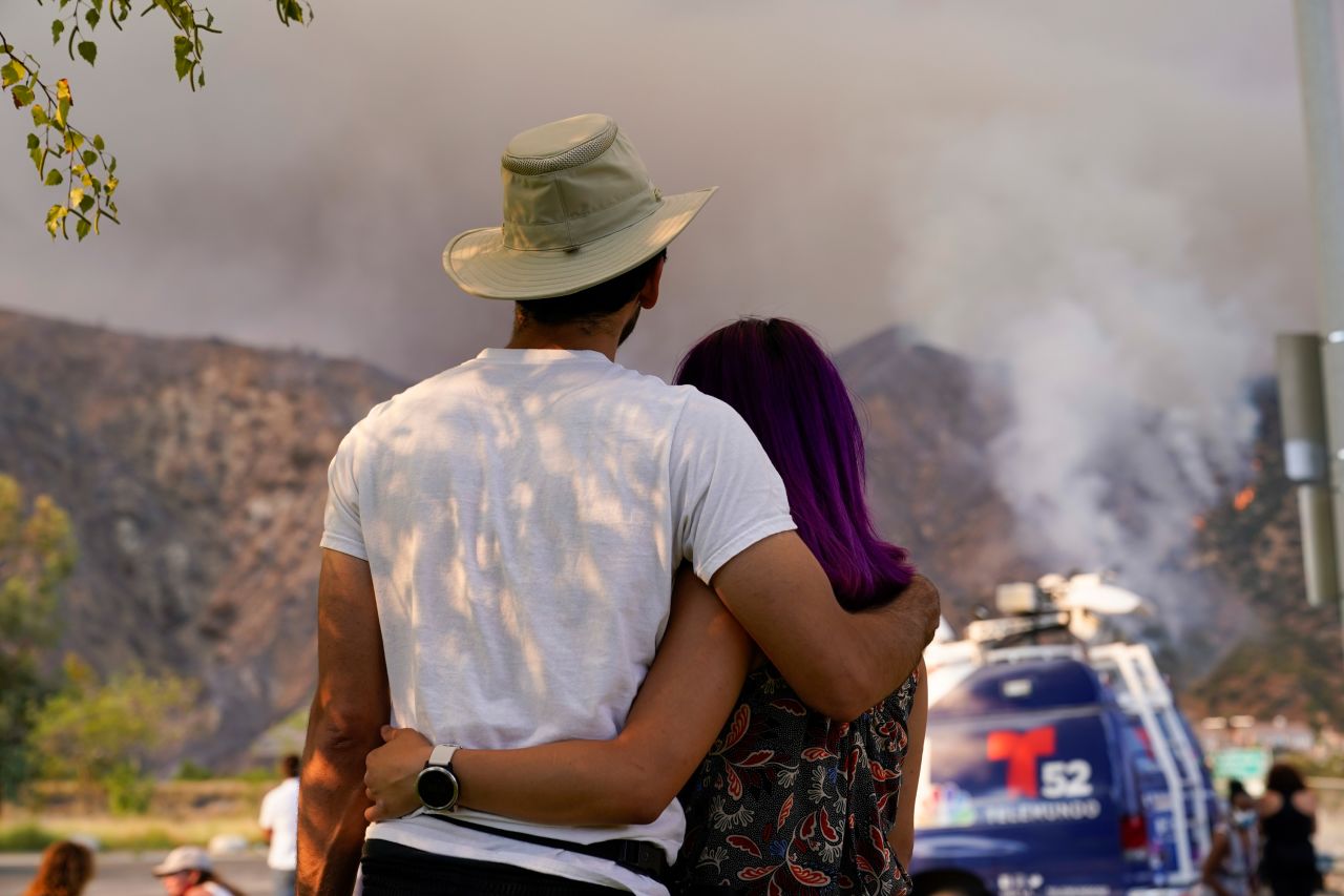 A couple watches the Ranch2 Fire from a distance on August 13, 2020.