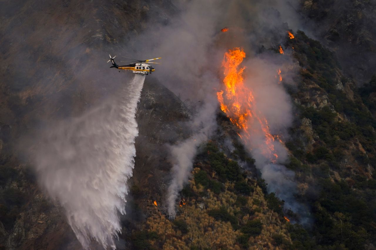 A helicopter makes a water drop over the Ranch2 Fire in Azusa, California, on August 13.