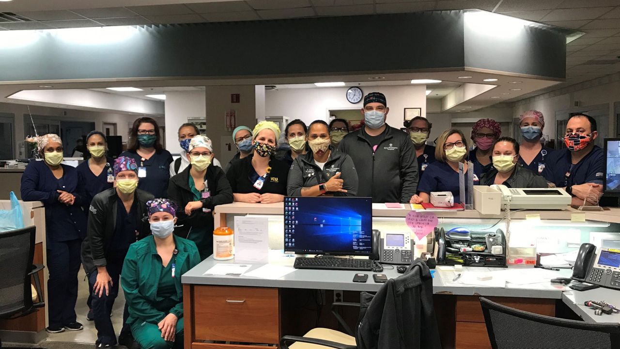 The ICU team at Mary Washington Hospital. Mason is in the front with the printed mask and yellow bouffant cap.
