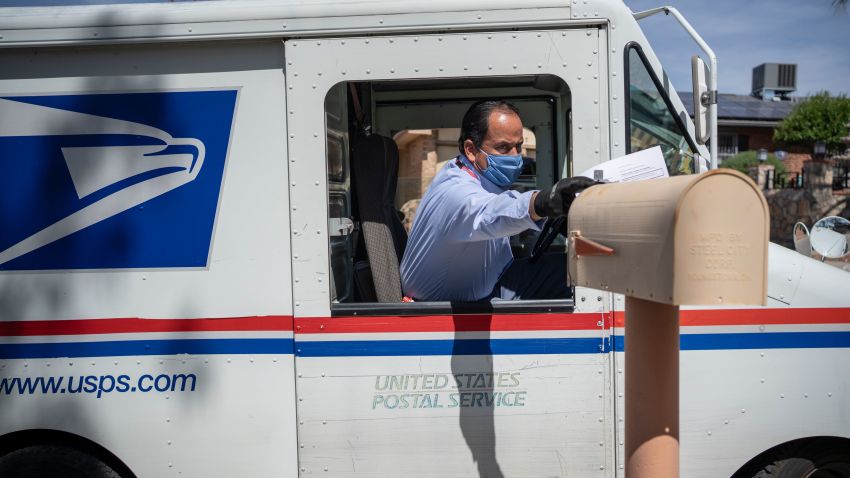 United States Postal Service mail carrier Frank Colon, 59, delivers mail amid the coronavirus pandemic on April 30, 2020 in El Paso, Texas. - Everyday the United States Postal Service (USPS) employees work and deliver essential mail to customers. (Photo by Paul Ratje / AFP) (Photo by PAUL RATJE/AFP via Getty Images)