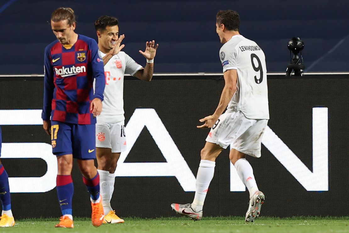 Lewandowski (right) celebrates with Coutinho after he scored. 