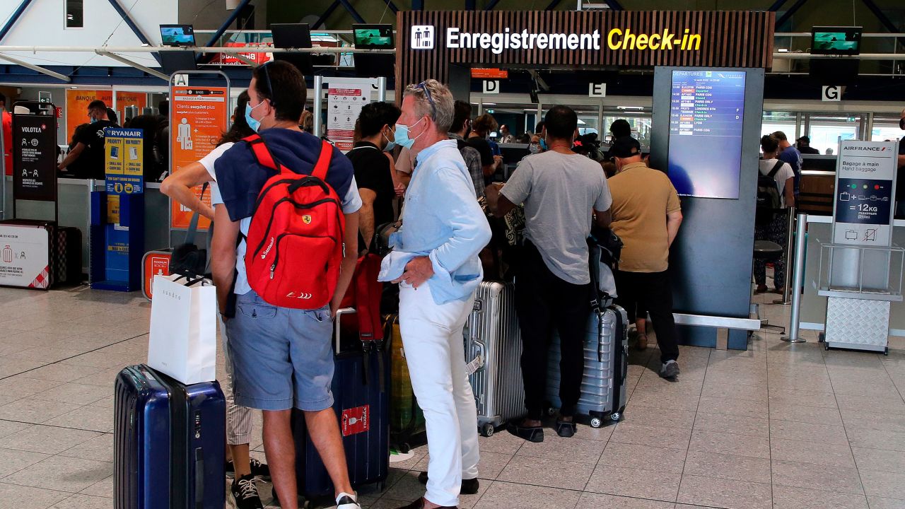 People queue at Biarritz Airport on August 14, 2020, the day before the UK imposed quarantine on people arriving from France.