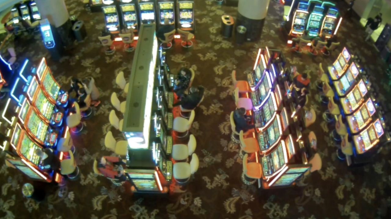 A 12-year-old girl (upper left) places bets on a poker machine at The Star Casino in Sydney, New South Wales, alongside her parents. 