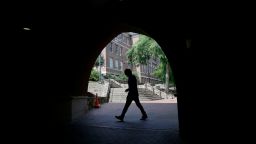 A pedestrian uses a tunnel walkway at the University of North Carolina in Chapel Hill, N.C., Tuesday, June 30, 2020. (AP Photo/Gerry Broome)