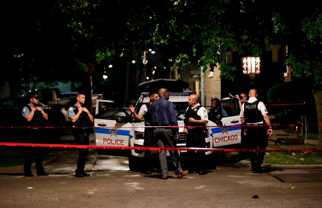 Police officers investigate the scene of a shooting in Chicago, Illinois, on July 21, 2020.