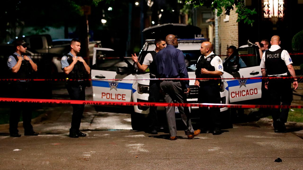 Police officers investigate the scene of a shooting in Chicago, Illinois, on July 21, 2020.