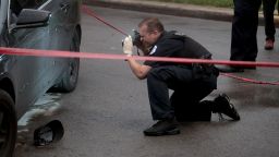 Police investigate the scene of a shooting in the Auburn Gresham neighborhood of Chicago, Illinois, on July 21, 2020.