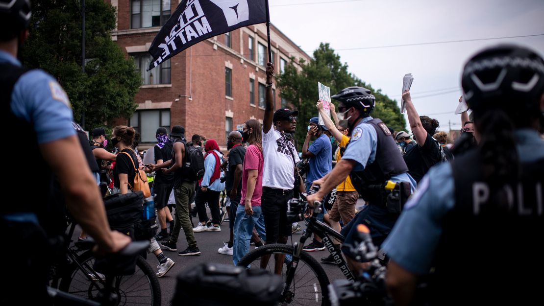 A Black Lives Matter activist holds a flag during a march through Chicago's South Side in protest of police misconduct.