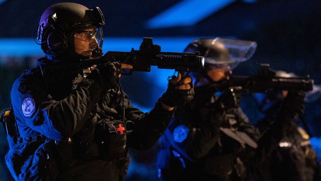 Portland police are seen in riot gear during a standoff with protesters in Portland, Oregon, on August 16, 2020.