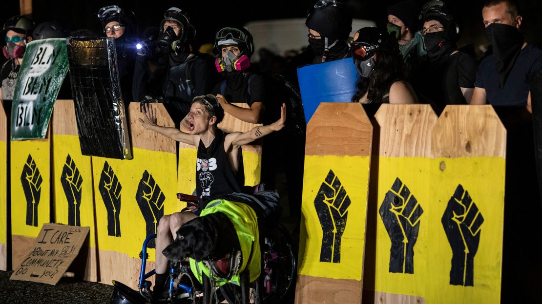 A protester screams at police during a standoff at a Portland precinct in Portland, Oregon, on August 15, 2020.