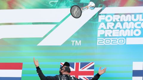 Hamilton celebrates on the podium after winning the Spanish Grand Prix.