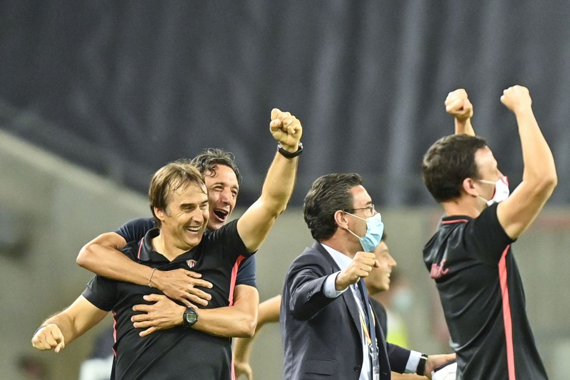 Sevilla's coach Julen Lopetegui (left) and staff celebrate on the final whistle after victory against Manchester United.
