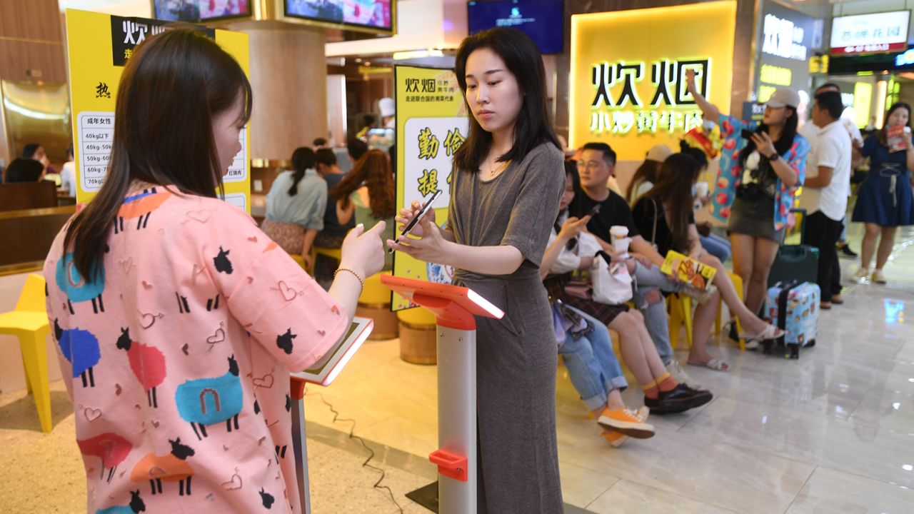 Diners are weighed at the Chuiyan Fried Beef restaurant in the city of Changsha, Hunan province.