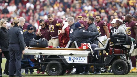 Alex Smith is helped off the field after his injury in November 2018. 