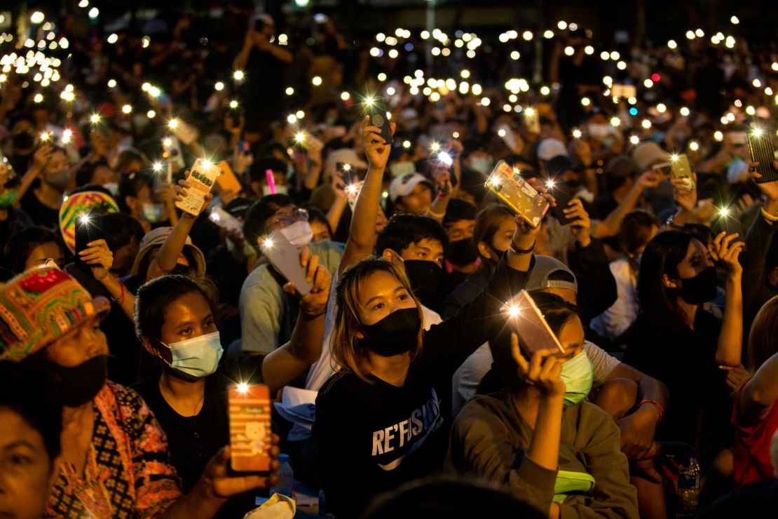 Students and anti-government protesters light up their phones at Democracy Monument on August 16, 2020 in Bangkok.