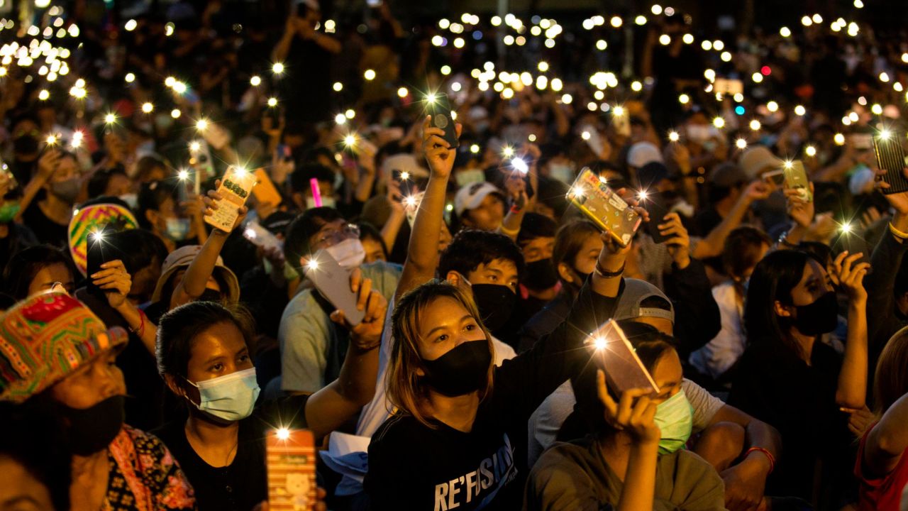 Students and anti-government protesters light up their phones at Democracy Monument on August 16, 2020 in Bangkok.