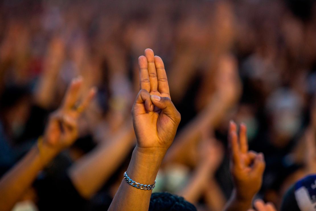 Protesters give a three finger salute at a rally at Democracy Monument on August 16, 2020 in Bangkok.