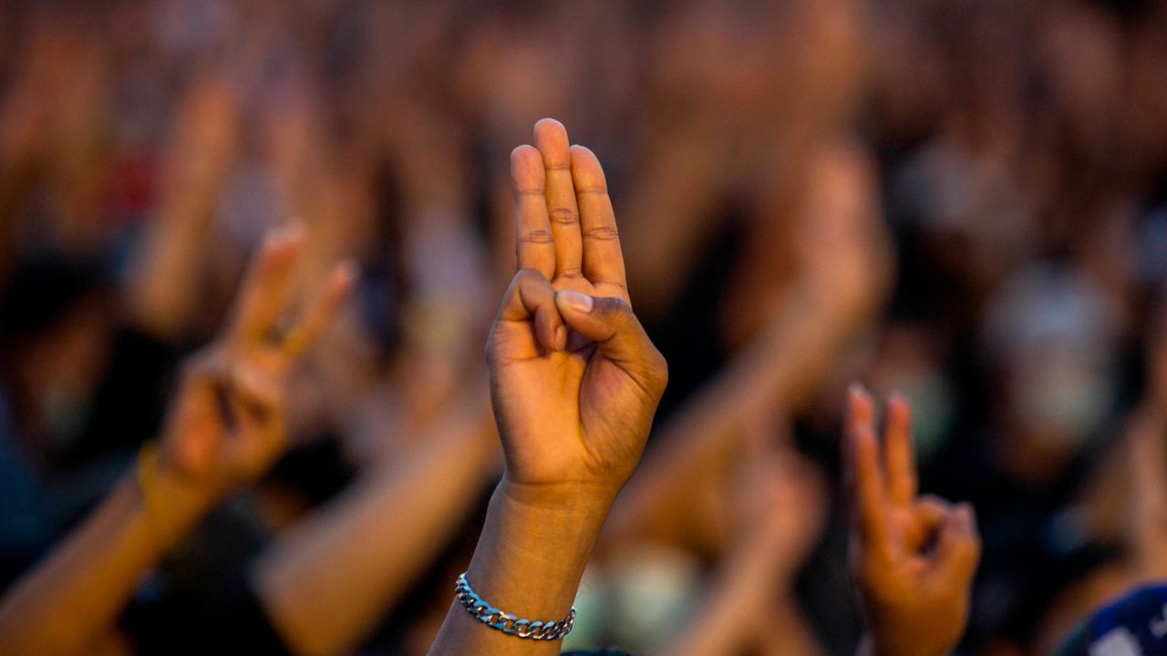 Protesters give a three finger salute at a rally at Democracy Monument on August 16, 2020 in Bangkok.
