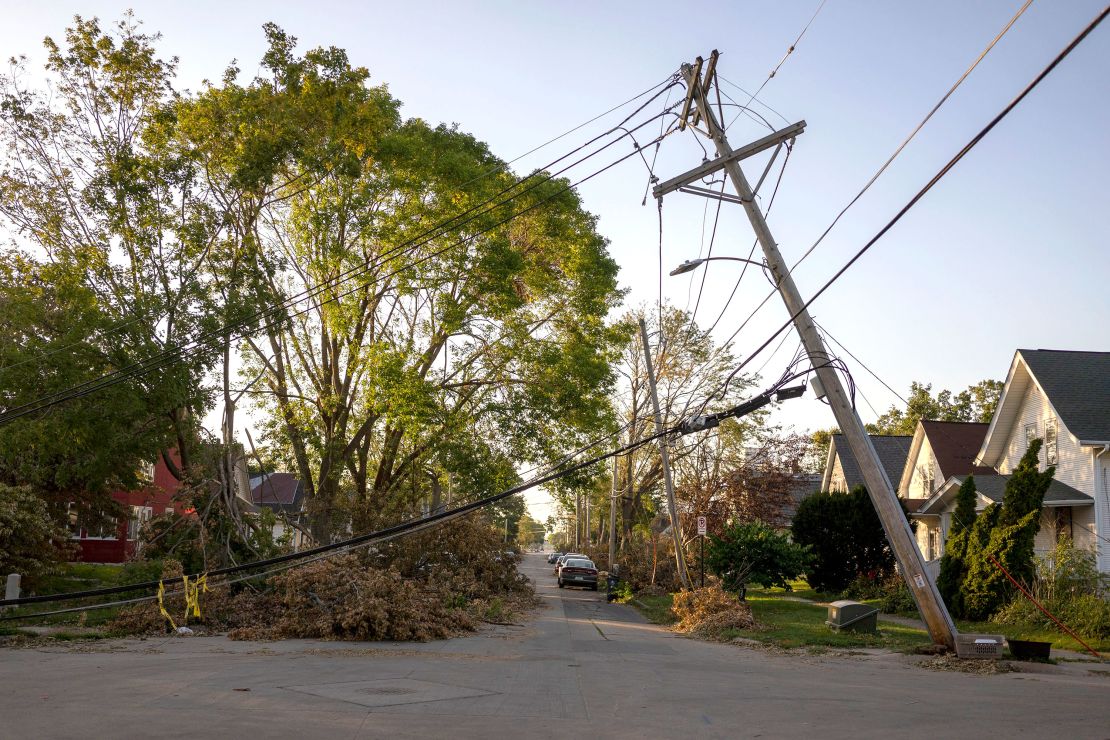 A downed power line leans over a street in Cedar Rapids, Iowa on Sunday, August 16, 2020. A rare Derecho storm battered large sections of Cedar Rapids leaving people homeless and without power.