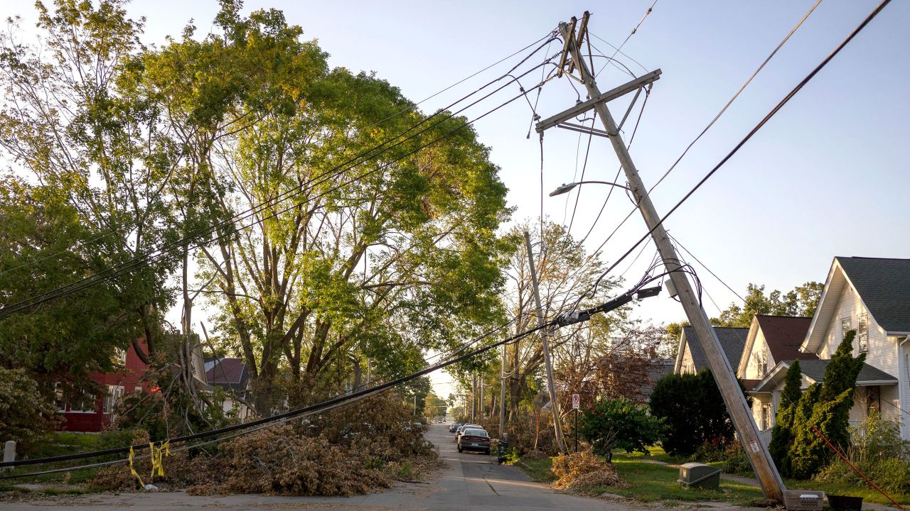 A downed power line leans over a street in Cedar Rapids, Iowa on Sunday, August 16, 2020. A rare Derecho storm battered large sections of Cedar Rapids leaving people homeless and without power.