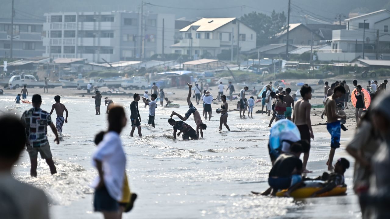 People cool off in the water at the beach during a summer heatwave in Kamakura, Kanagawa prefecture on August 15, 2020.