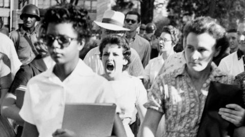 Elizabeth Eckford, one of the "Little Rock Nine," ignores the jeers and stares of fellow students on her first day of class at Little Rock's Central High School in 1957.