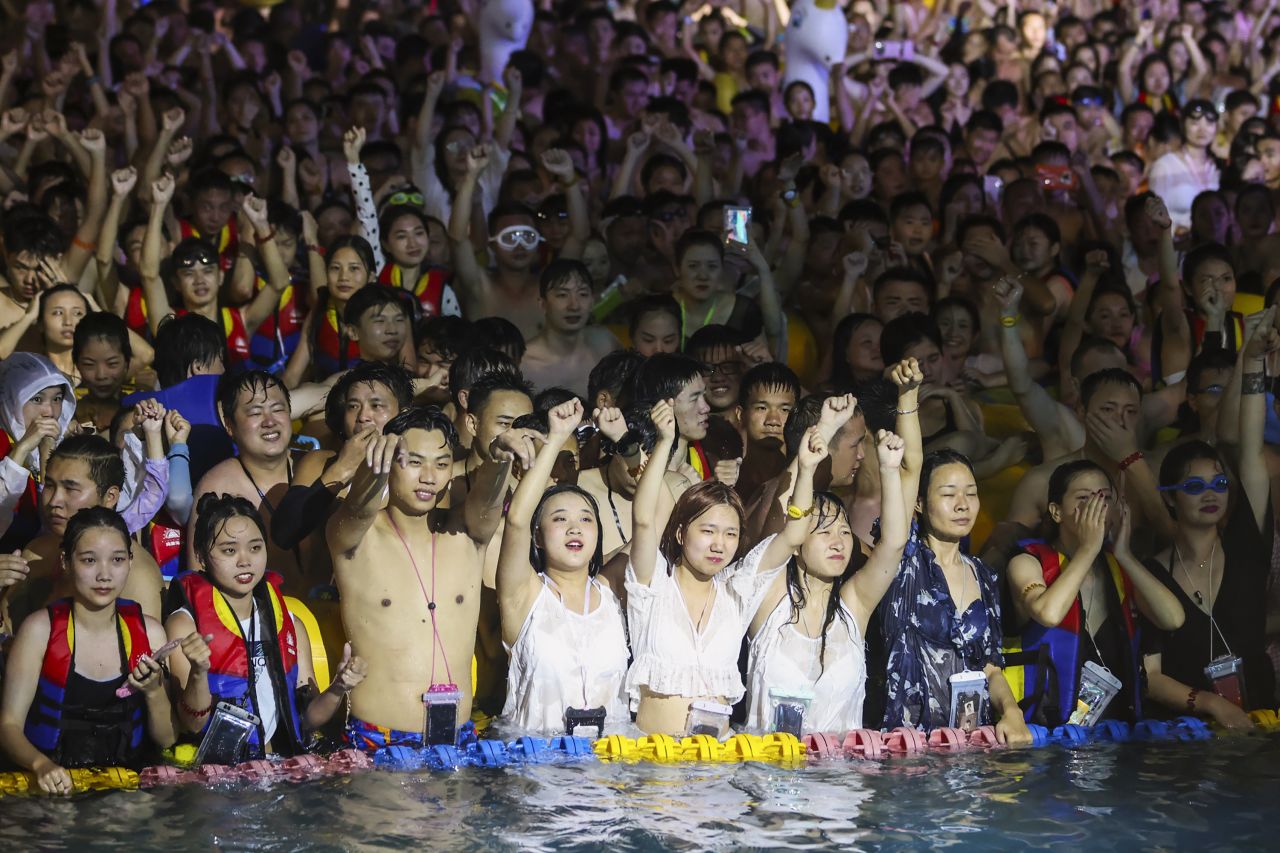 Partygoers stand shoulder to shoulder as they watch an eletronic music performance at the Wuhan Maya Beach Water Park.