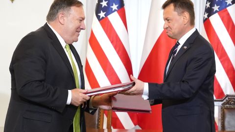 US Secretary of State Mike Pompeo and Polish Minister of Defense Mariusz Blaszczak exchange documents after signing the US-Poland Enhanced Defense Cooperation Agreement in the Presidential Palace in Warsaw, Poland, on August 15, 2020.