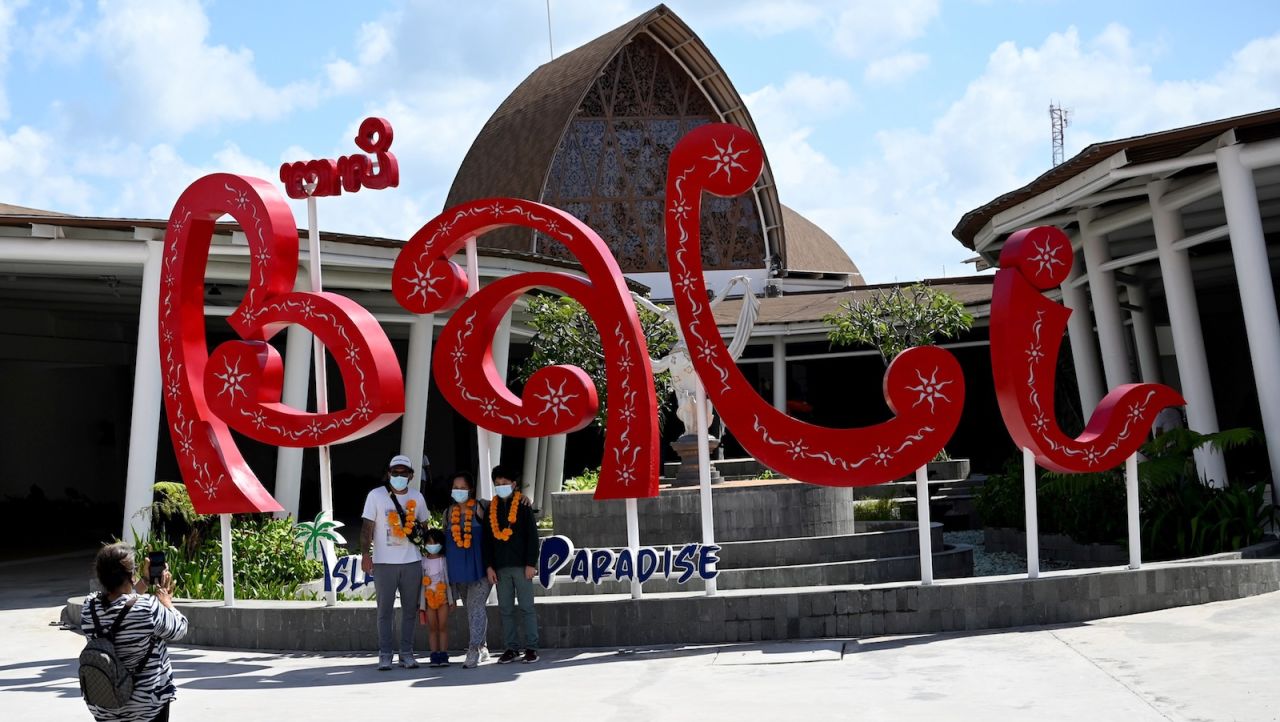 <strong>Domestic tourism: </strong>People have their pictures taken outside the airport in Bali on July 31.  