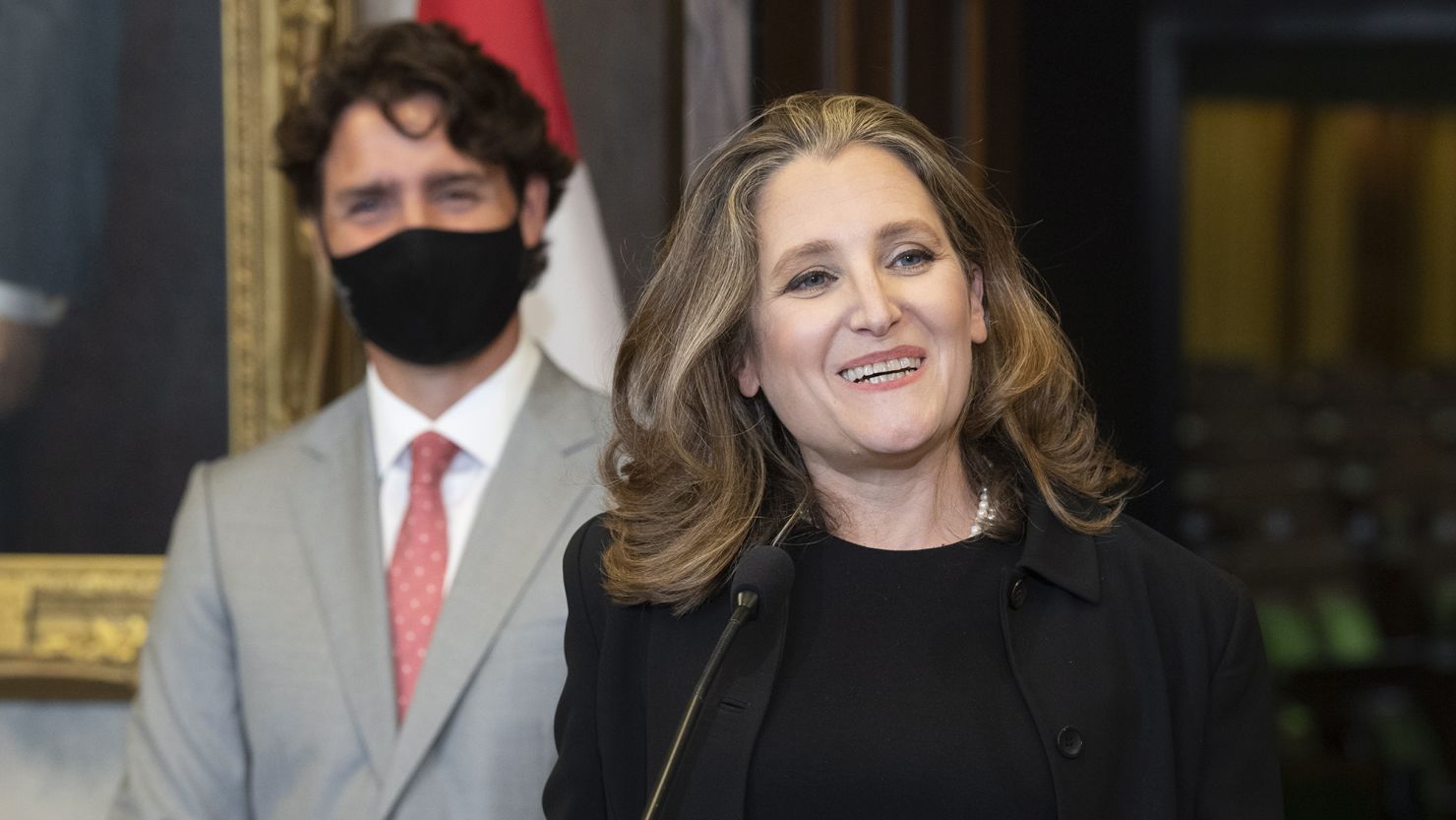 Finance Minister Chrystia Freeland smiles as she responds to a question as Prime Minister Justin Trudeau looks on during a news conference on parliament hill in Ottawa on Tuesday.