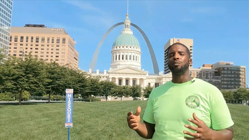 Reuben Gill of Missouri speaks in front of the Old Courthouse and Gateway Arch in St. Louis.