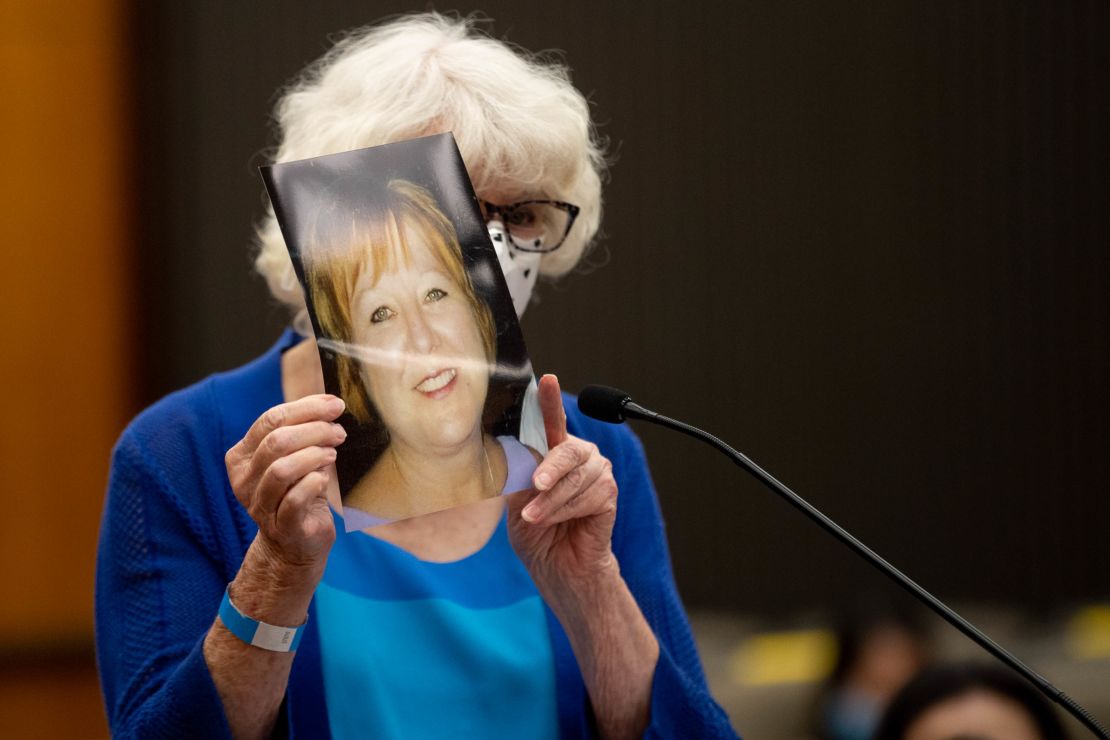 Dolly Kreis holds a photo of her daughter Debbie Strauss and shows it to Joseph James DeAngelo, known as the Golden State Killer, who did not look back, during the first day of victim impact statements.
