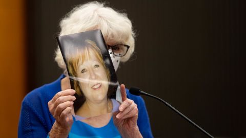 Dolly Kreis holds a photo of her daughter Debbie Strauss and shows it to Joseph James DeAngelo, known as the Golden State Killer, who did not look back, during the first day of victim impact statements.
