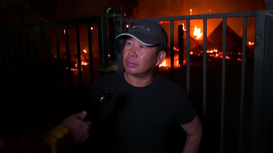 Thuy Ngo stands Wednesday in front of his burning barn near Vacaville.