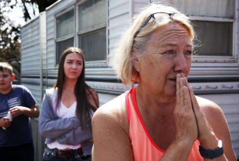 Kathy Mathison looks at the still-smoldering wildfire on August 16 that, just a day before, came within several feet of her home in Bend, Oregon.