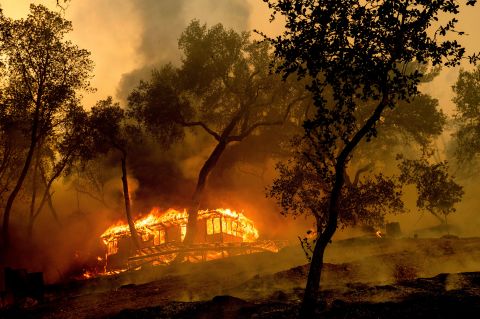 Flames from the Hennessy Fire consume a cabin at the Nichelini Family Winery in Napa County on August 18.